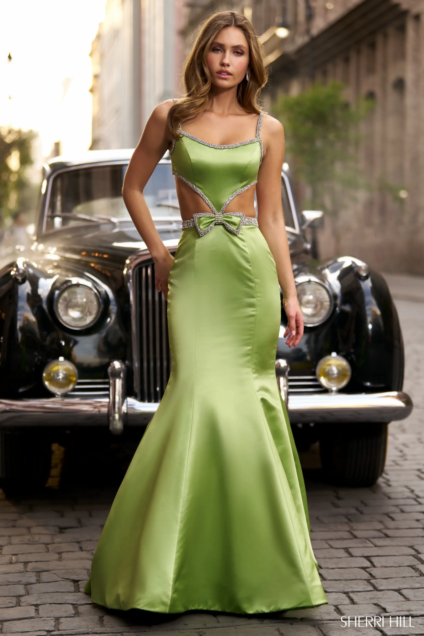 model wearing green Sherri Hill dress