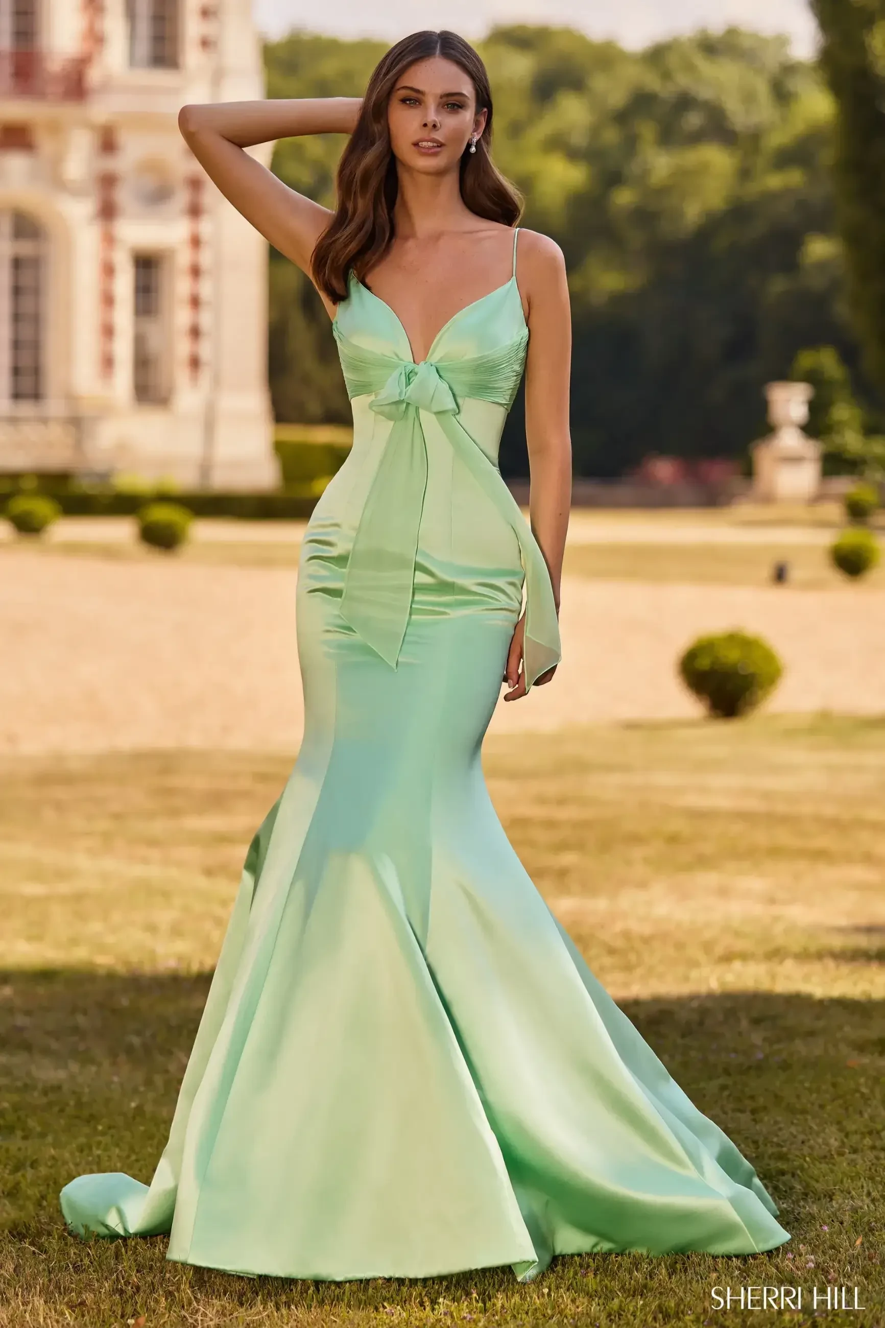 model wearing green Sherri Hill dress